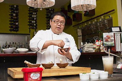 Chef Dennis leading a cooking class