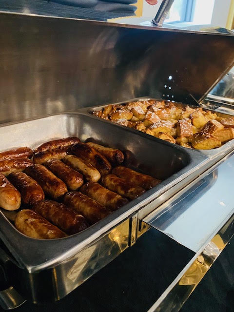 Hot breakfast buffet with sausage and breakfast potatoes at Blue Bamboo